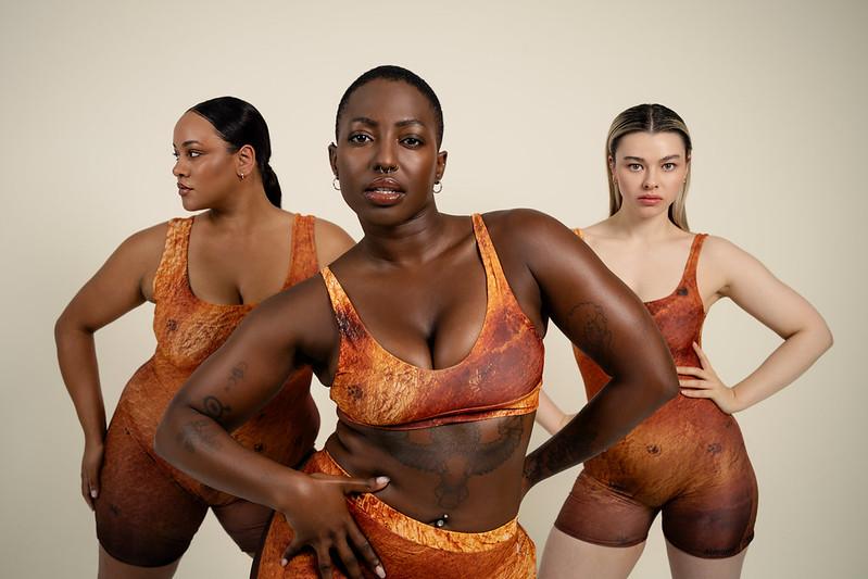 Three models in Subway Skins jacket potato-inspired shapewear bodysuits and shorts, photographed together for The Robin Collective