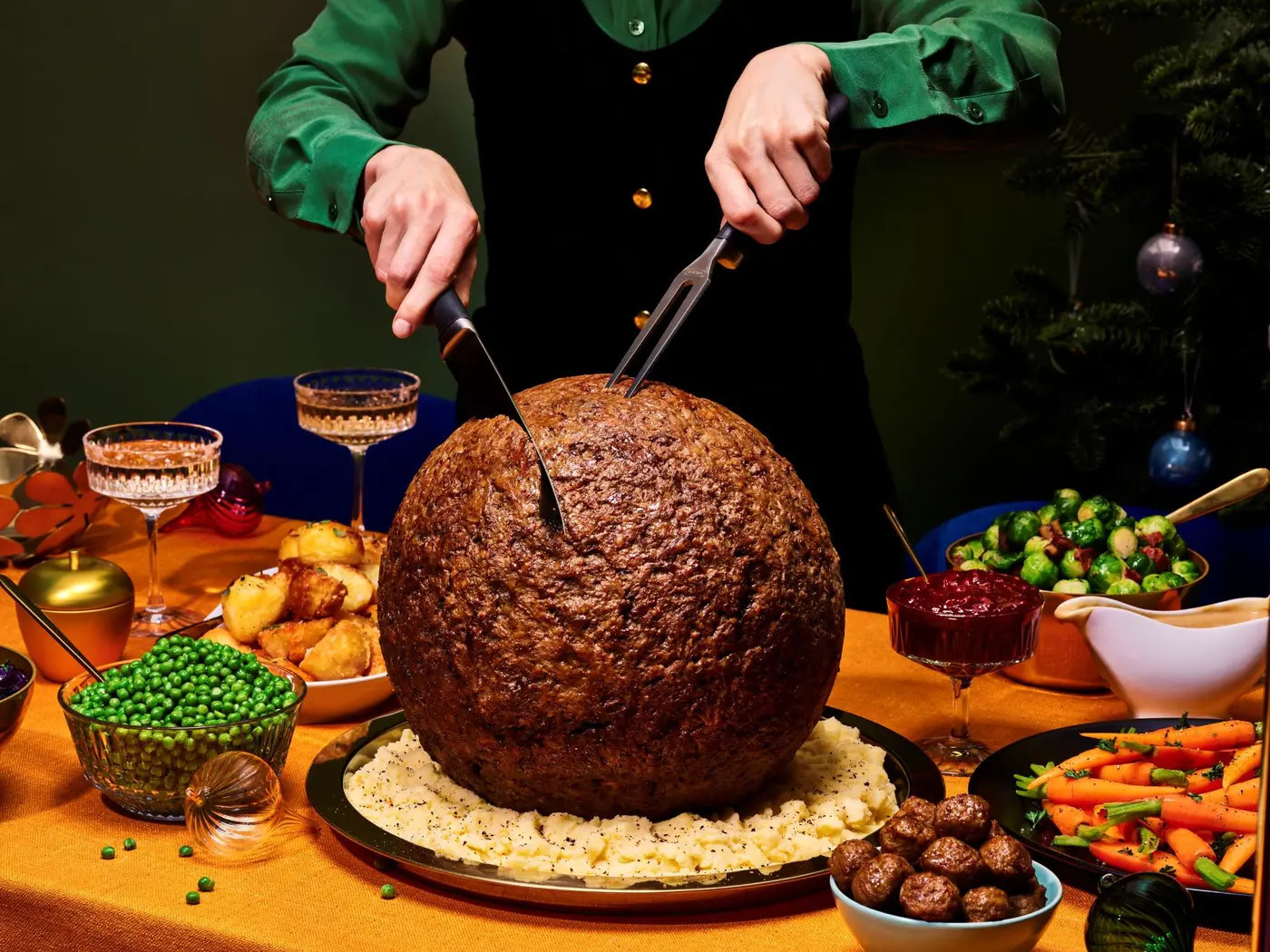 Carving IKEA's 4.5kg Turkey-Sized Meatball at a Christmas dinner table by The Robin Collective