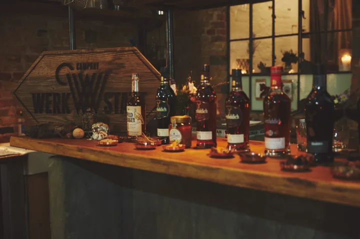 Lineup of Glenfiddich Experimental Series whisky bottles on a wooden tasting bar